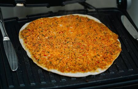 Turkish a kind of meat pizza (lahmacun) cooking in a toaster at home