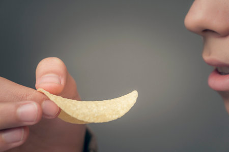 the person eating the classic potato chipsの写真素材