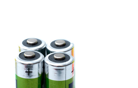 four battery plus poles and isolated background with white