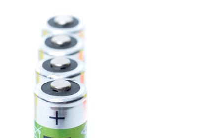 close-up four AA batteries plus terminals and white backgroundの写真素材