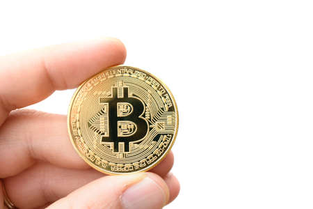 Close up shot of a golden Bitcoin coins on white background with man hand