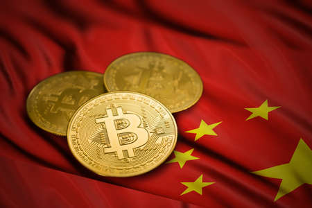 close-up gold colored bitcoin coin on china flagの写真素材
