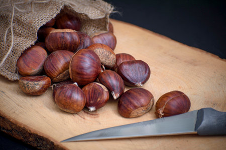 chestnuts out of the pouch on wooden floorの写真素材