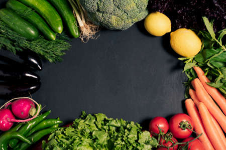 fresh vegetables on black wooden background