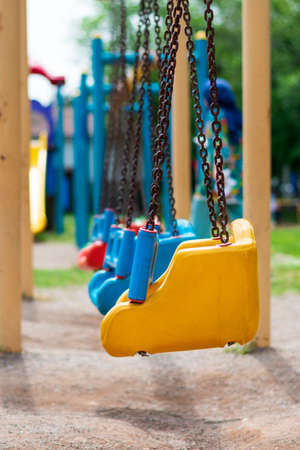 yellow swing in the playground and blur backgroundの写真素材
