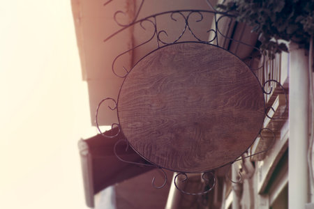 Round shape wooden blank signboard. blank sign for restaurant or cafe on the streetの写真素材