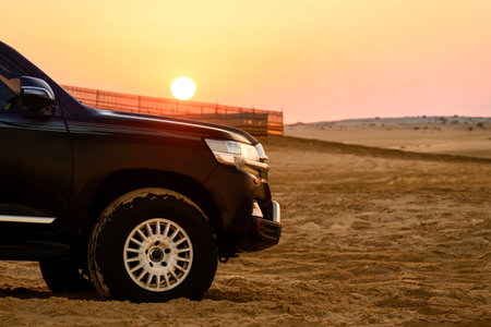 Desert landscape and off-road vehicles on desert safari at sunset in Doha, Qatar