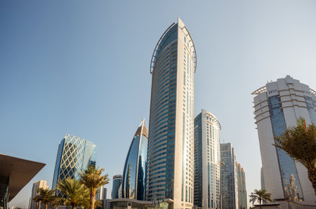 Bottom view of skyscrapers and tall buildings in Doha, Qatar with wide angle skyの写真素材