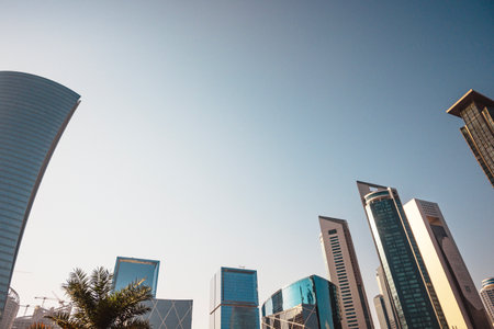 Bottom view of skyscrapers and tall buildings in Doha, Qatar with wide angle skyの写真素材
