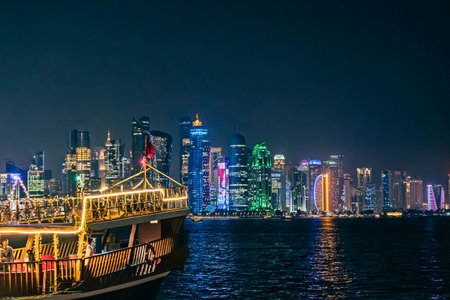 View of seaside tour boat and buildings in the corniche area of ââDoha, Qatarの写真素材
