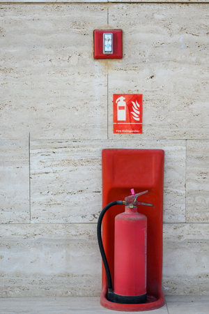 emergency fire extinguisher standing on the wall