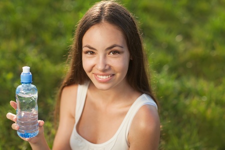 beautiful girl holding and drinking water の写真素材