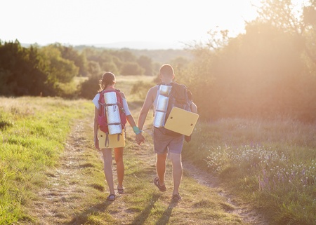 Two tourists make hiking the trail in the woodsの写真素材