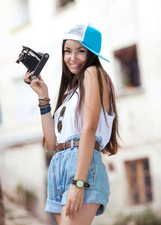 Young, beautiful woman with retro camera  Beautiful girl hipster filming の写真素材