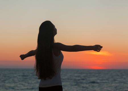 Girl in lotus pose at sunset Asian Caucasian female model の写真素材