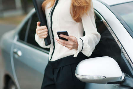 Young beautiful woman writes an SMS to your mobile phone  