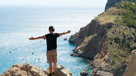 Man standing on a rock by the sea   Concept of freedom の写真素材