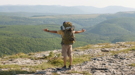 guy in the mountains at sunset  the concept of freedomの写真素材