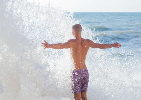 Guy walking on the beachの写真素材