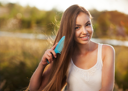 beautiful girl combs her hair Asian appearanceの写真素材