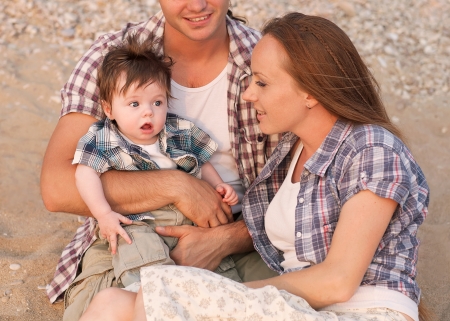 happy young family spending time outdoor on a summer dayの写真素材