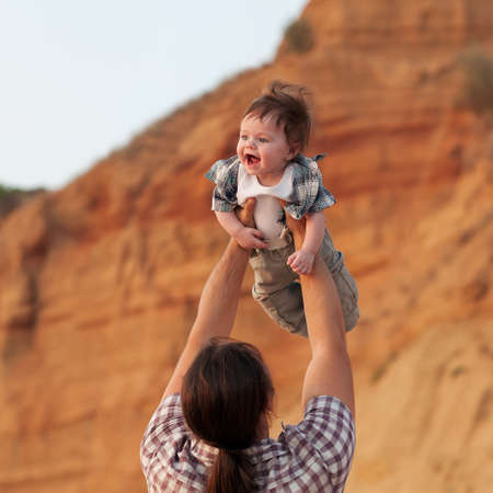 happy father and son playing on sky backgroundの写真素材