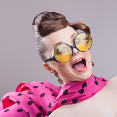 sexy retro woman in big glasses and skarf, screaming の写真素材