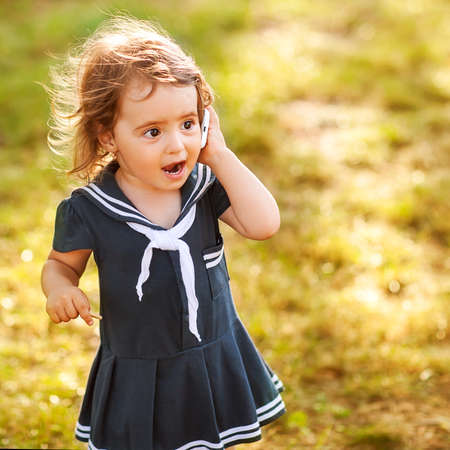 cute little girl talking on the phoneの写真素材