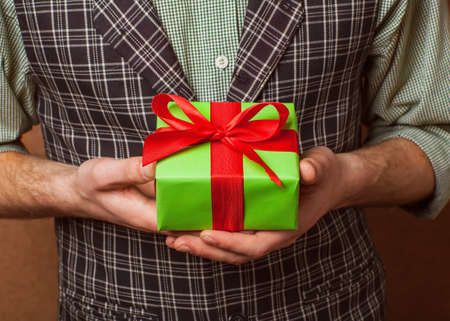 guy holding christmas gift box with hand の写真素材