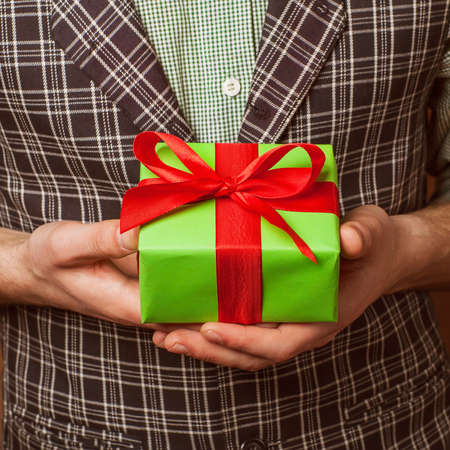 guy holding christmas gift box with hand の写真素材