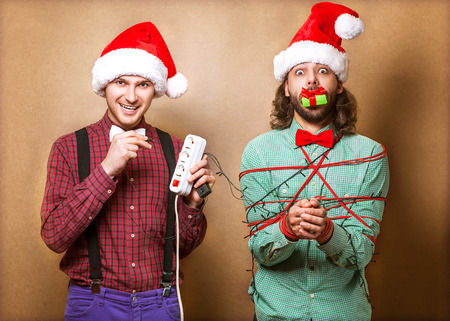 two guys to play with Christmas garlandの写真素材