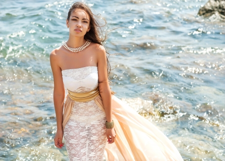 fashion portrait of a girl on the seaの写真素材