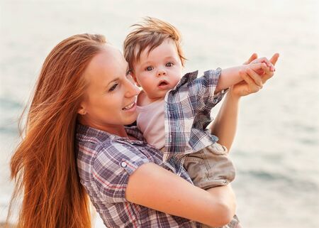 happy family having fun. baby boy with brown hair and his mother の写真素材