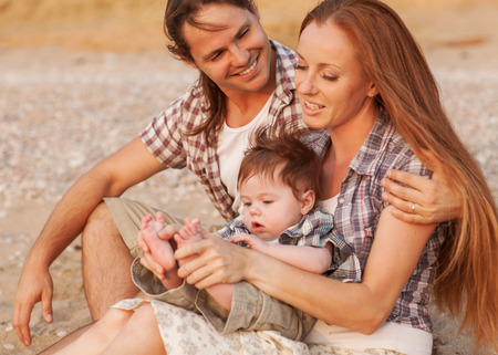 Photo of happy family on the beach on summerの写真素材