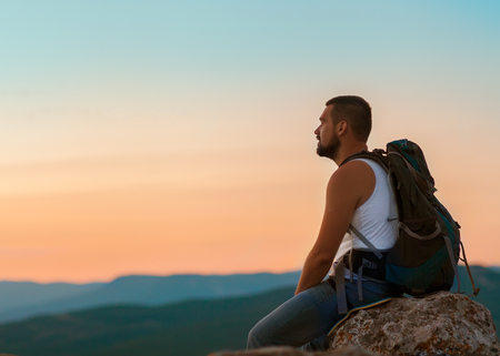 guy in the mountains at sunset. the concept of freedomの写真素材