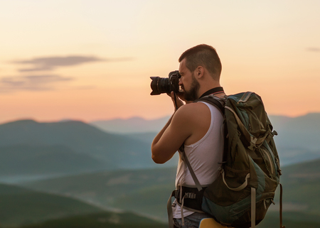 Nature photographer taking photos in the mountainsの写真素材