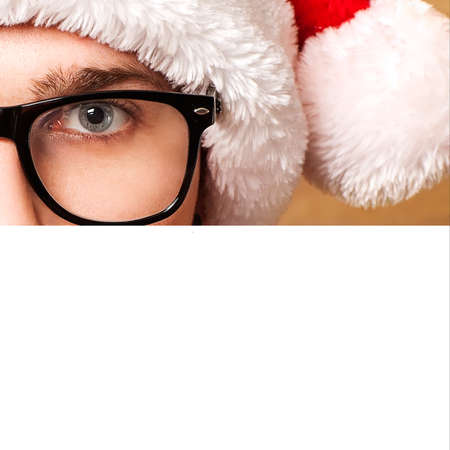 Santa Claus pointing in white blank sign with smile, isolated on backgroundの写真素材