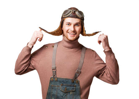 Handsome welcoming man smiling - isolated over a white background and  posing in vintage helmet and glasses pilot の写真素材