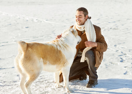 Man and central Asian shepherd walk in the lake