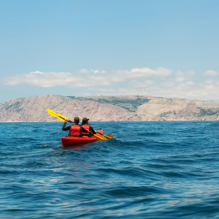 traveler kayaking in the thai ocean from backward viewの写真素材