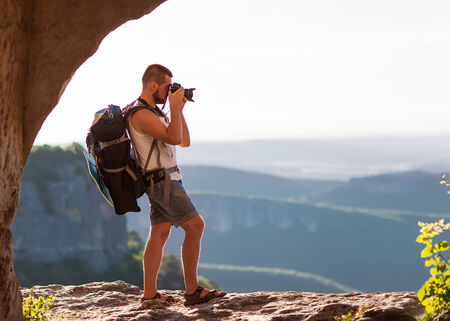 Nature photographer taking photos in the mountains