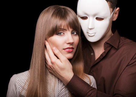 Fashion Happy Couple in Love holding a white mask face  Psychological concept  Duality look at relationships の写真素材