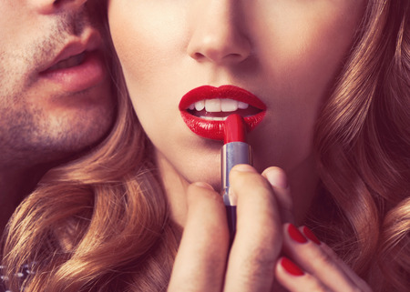 Beautiful portrait of young man lips red lipstickの写真素材