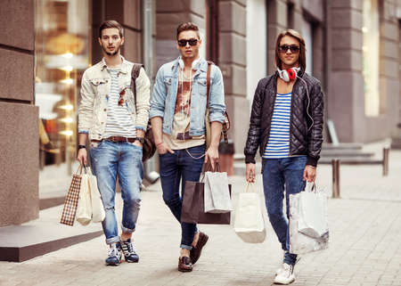 Three Young male fashion shop shopping walkの写真素材