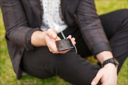 Close up of a man using mobile smart phoneの写真素材