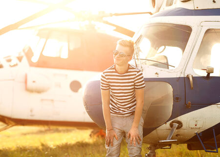 fashion man near helicopters at the airportの写真素材