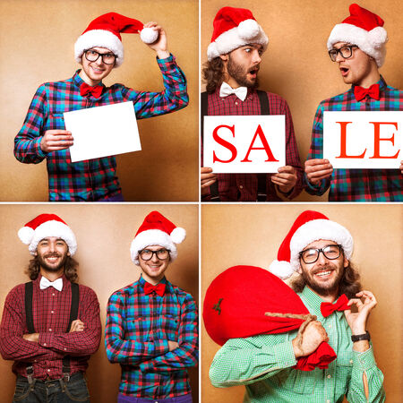 Two emotional Santa Claus dressed in clothes hipster standing near a wallの写真素材