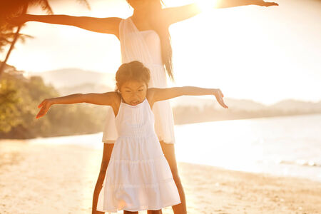 mother and daughter happy in love at sunsetの写真素材