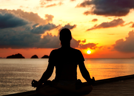 man doing yoga at sunsetの写真素材