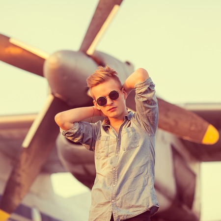 fashion man near helicopters at the airportの写真素材